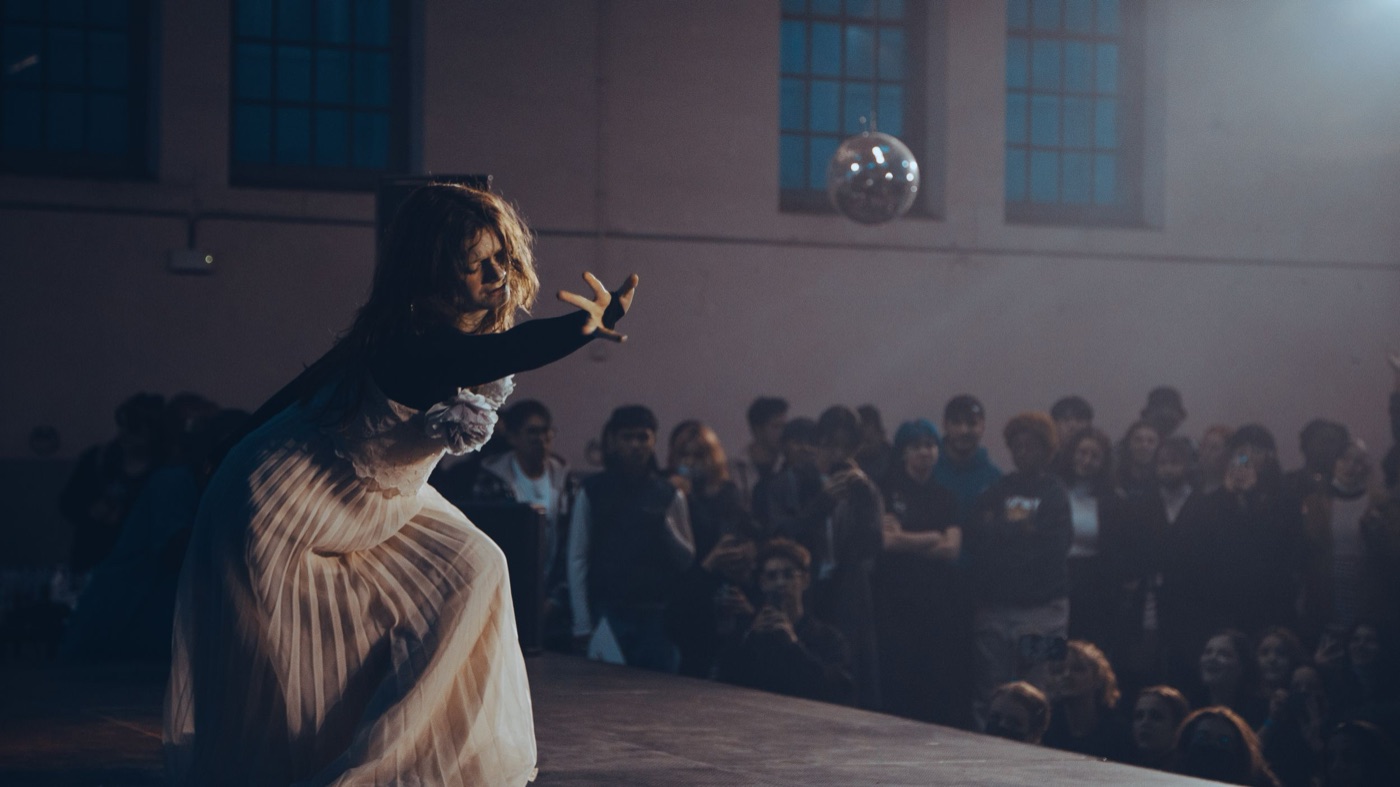 Dancer performing on stage in front of a crowd